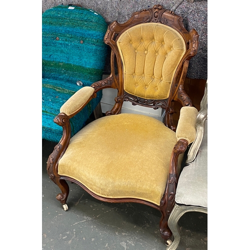 834 - A Victorian carved walnut and button upholstered armchair, with ceramic casters, 71cmW