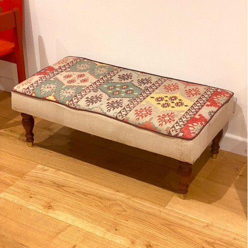 832A - A kilim style upholstered centre stool on turned legs, 102x51x36cm