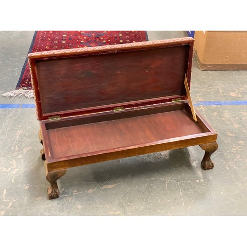 1106 - A long upholstered footstool with hinged seat, 78cmL