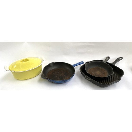 367A - A Le Creuset yellow lidded crock, 27cmW; together with three cast iron skillets, the smallest Le Cre... 