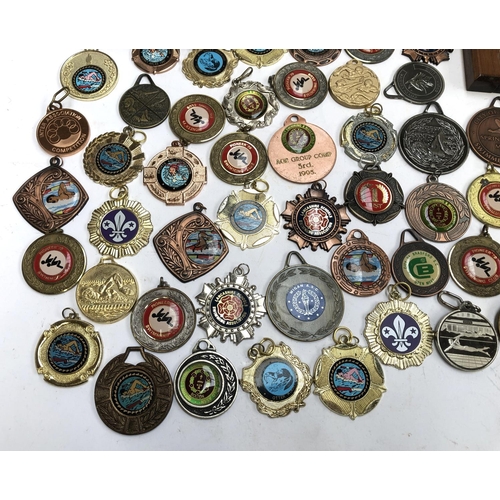 247 - A quantity of swimming and football medals, some in fitted cases