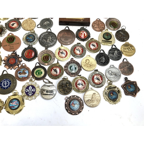 247 - A quantity of swimming and football medals, some in fitted cases