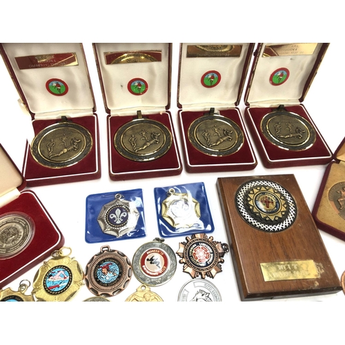 247 - A quantity of swimming and football medals, some in fitted cases