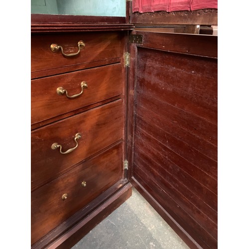 1142 - A George III mahogany and pine press cupboard, probably early 19th century, with a shallow pediment ... 