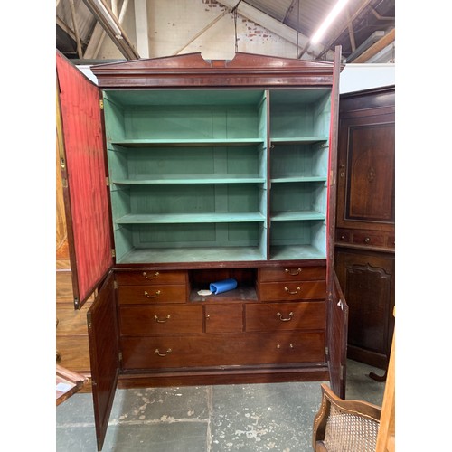 1142 - A George III mahogany and pine press cupboard, probably early 19th century, with a shallow pediment ... 