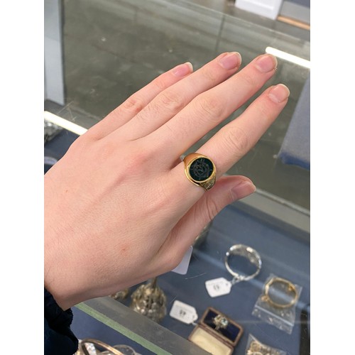 27 - A heavy Victorian 18ct gold signet ring set with a bloodstone intaglio, engraved with the monogram G... 