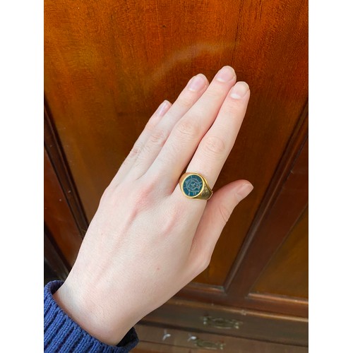 27 - A heavy Victorian 18ct gold signet ring set with a bloodstone intaglio, engraved with the monogram G... 