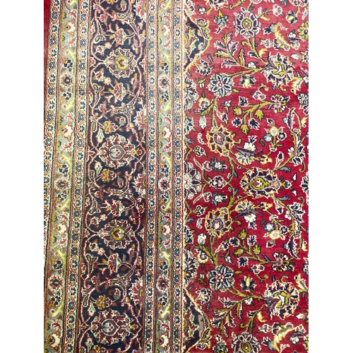 622 - A very large Persian carpet, red ground, 385x295cm