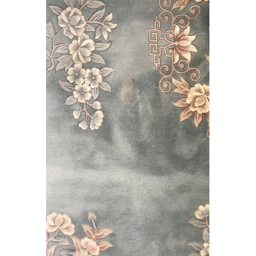 624 - A large blue ground floral wool rug, 378x271