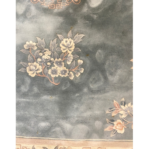 624 - A large blue ground floral wool rug, 378x271