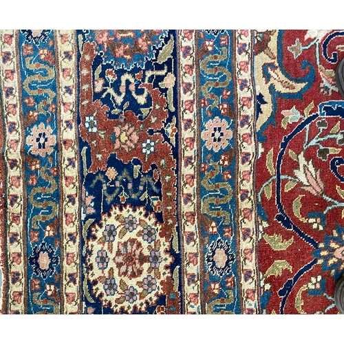 633 - A very large Persian wool rug with central medallion, 450x345cm