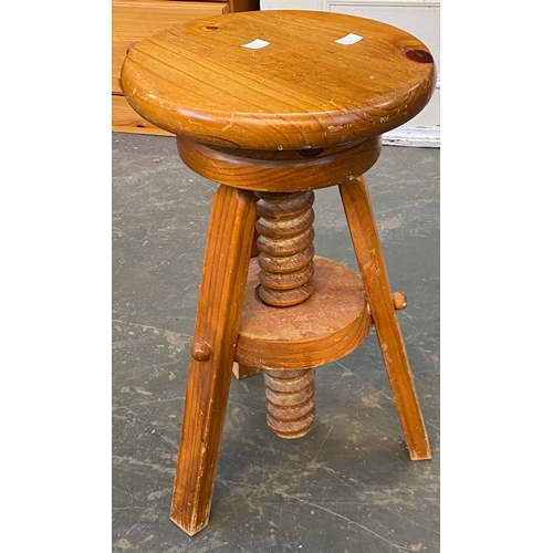 775 - A 'rustic' style three legged stool; together with an adjustable pine stool