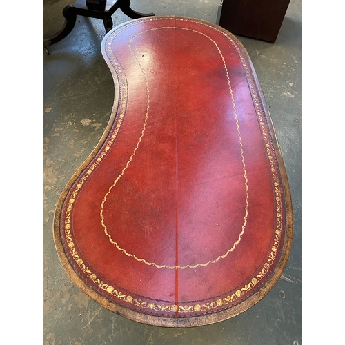 844 - An oval centre table, with red leather inset top, on twin end supports (legs repaired), 71cmH