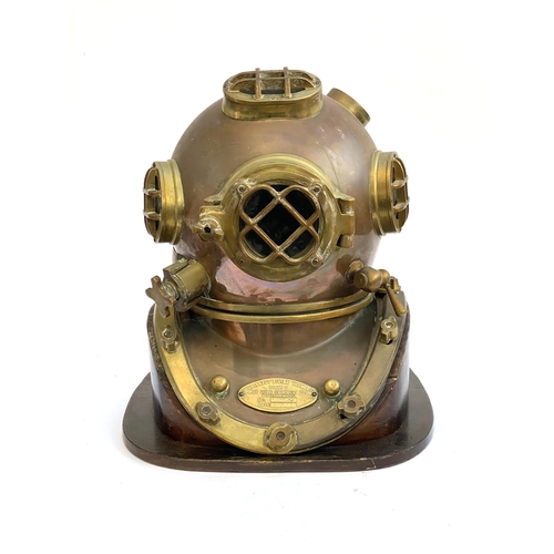 263 - A brass and copper US navy diving helmet, bears a label 