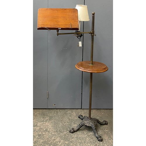 739 - An early 20th century cast iron, brass and mahogany adjustable reading stand with electrified light ... 