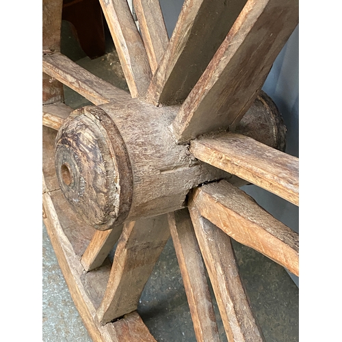 956 - A rustic wooden wagon wheel, 80cmD