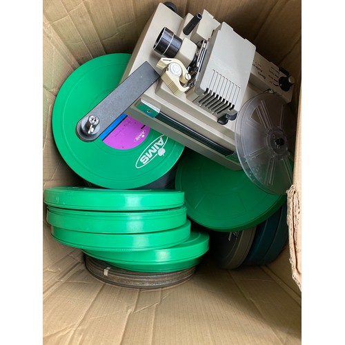 312A - A quantity of film reels together with a Boots Auto Zoom projector