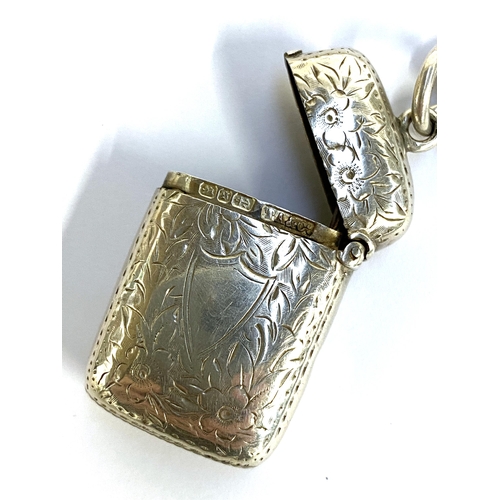 14 - A silver vesta case, floral engraving, hallmarked for Birmingham 1892, on silver chain with hallmark... 