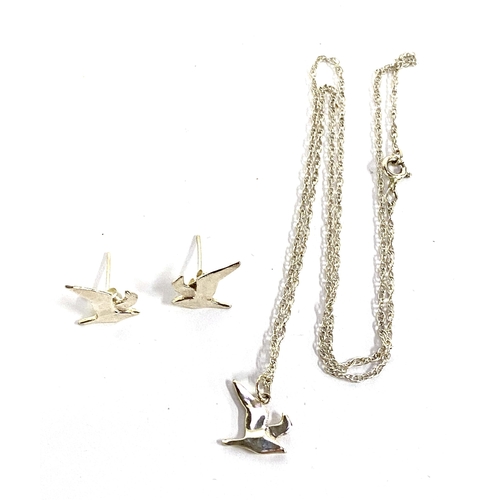 27 - A 925 silver stylised flying bird pendant on chain, together with a matching pair of stud earrings, ... 