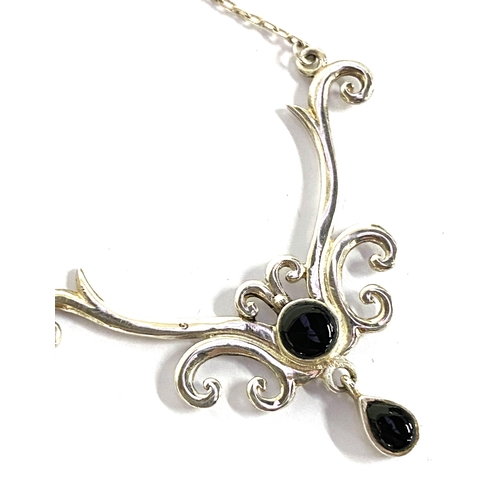 28 - A 925 silver and onyx necklace with lavalier drop, together with two pairs of similar silver art nou... 