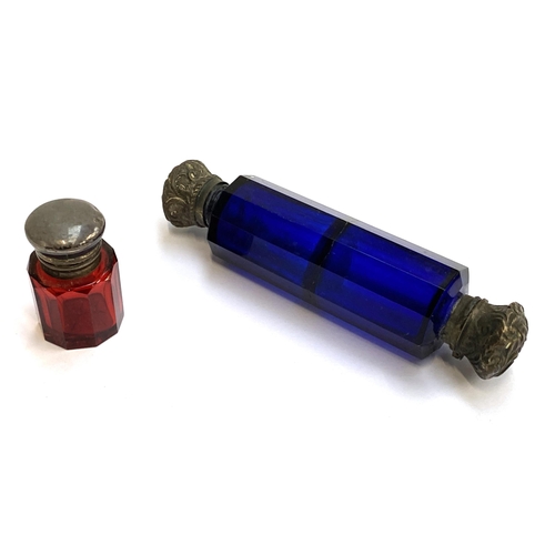 63 - A small silver mounted ruby glass dressing table scent bottle, 4.3cmH; together with a blue glass do... 