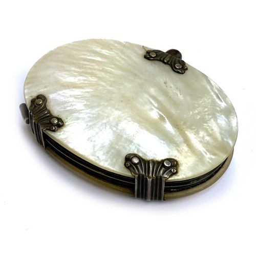 64 - An early 19th century white metal and mother of pearl sliding magnifying glass, 6.5cmW