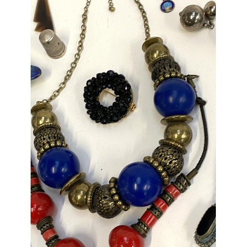 5 - A mixed lot of jewellery to include white metal tribal style earrings; carved jade type buffalo figu... 