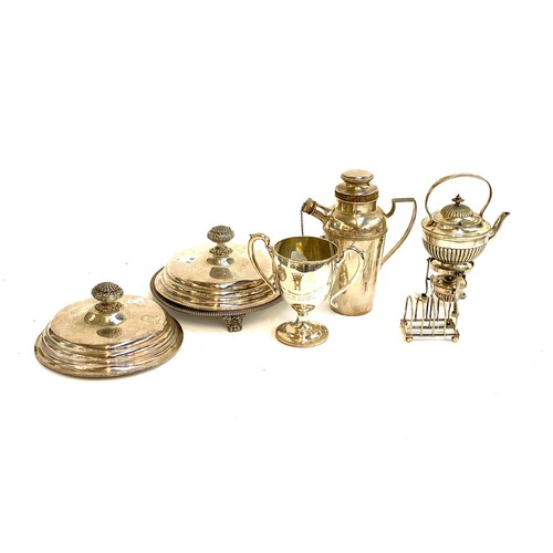 84 - A mixed lot of plated items to include a salver; cocktail shaker; twin handled trophy; a five divisi... 