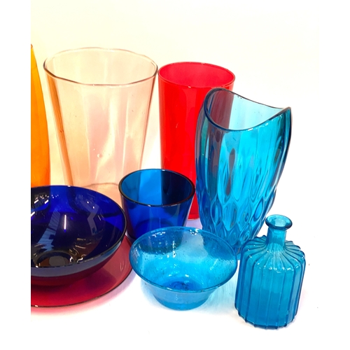 129 - A mixed lot of coloured glass, to include various tall glasses, tallest vase 41cmH, one blue hand bl... 