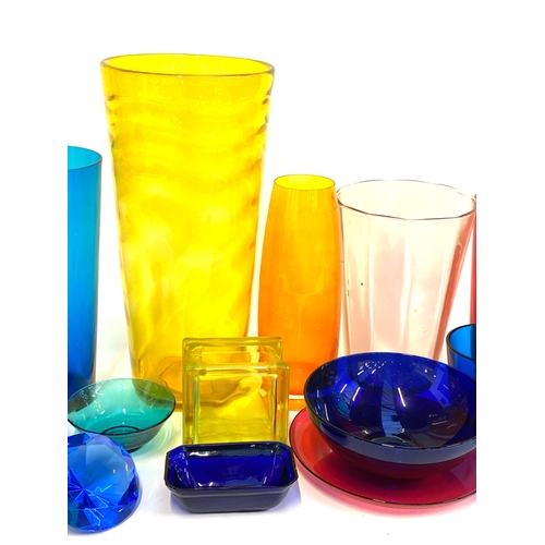 129 - A mixed lot of coloured glass, to include various tall glasses, tallest vase 41cmH, one blue hand bl... 