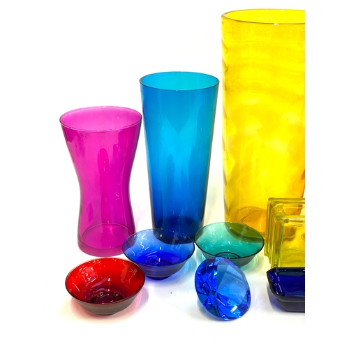 129 - A mixed lot of coloured glass, to include various tall glasses, tallest vase 41cmH, one blue hand bl... 