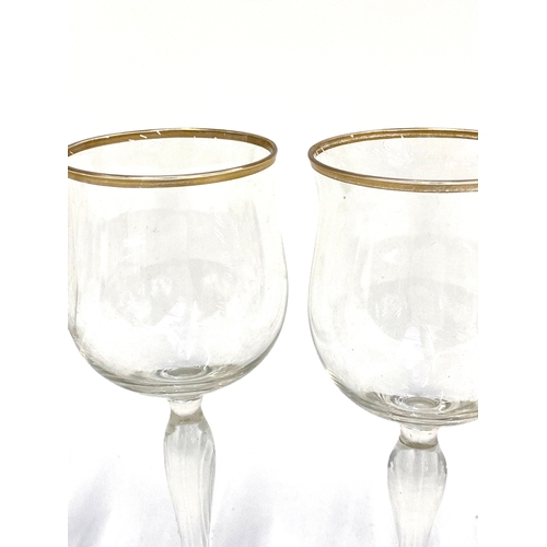 132 - A set of eight wine glasses with gilt rim and tapering stem, 20cmH