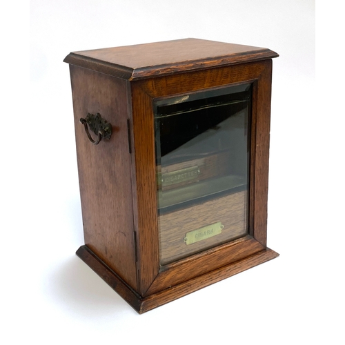 281 - A late Victorian oak and glazed smoker's cabinet, the locking door opening to drawers and brass fitt... 