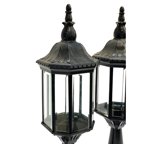 262 - A pair of black painted metal octagonal lanterns with bevelled glass, 62cmH