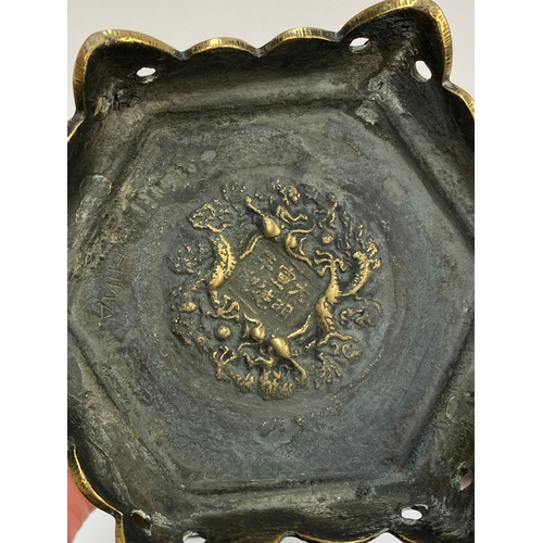 289 - A Chinese hexagonal brass planter engraved with flowers and figures, with pierced foot, marked to ba... 