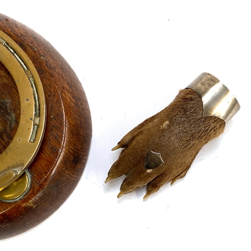 306 - Taxidermy interest: An early 20th century otters pad mounted as a brooch; together with a 19th centu... 