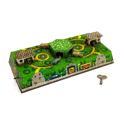 316 - A vintage Russian Aemompacca tinplate windup clockwork model of a bus station, with key