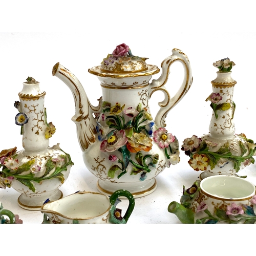 167 - A quantity of 19th century English florally encrusted miniature porcelain to include teapots, coffee... 