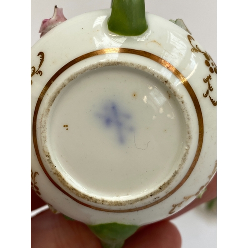 167 - A quantity of 19th century English florally encrusted miniature porcelain to include teapots, coffee... 