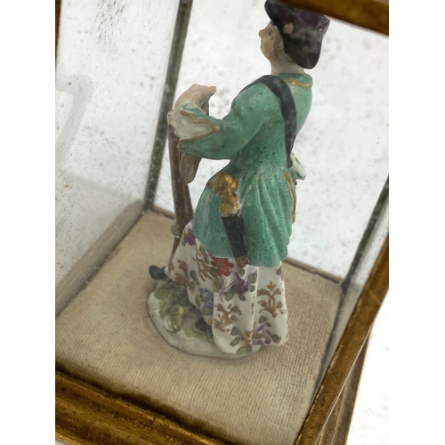 168 - A pair of 19th century continental Meissen style miniature porcelain figures of a huntsman and compa... 