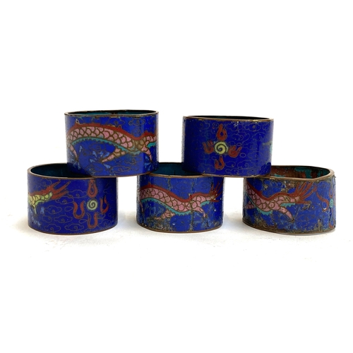 184 - A set of five Chinese cloisonne enamel napkin rings (af), dragons chasing a flaming pearl on a dark ... 