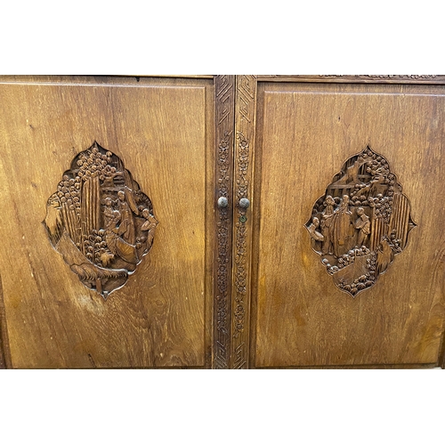 789 - A Chinese camphorwood cabinet, 20th century, the carved doors opening to two shelves, 117x45x104cm