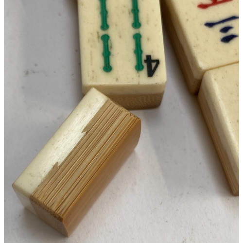 342 - An early 20th century mahjong set, bone and bamboo pieces, together with a set of racks, 152 pieces