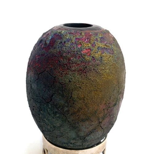 188 - A studio pottery egg shaped vase with a raku type glaze, 9.5cmH, on a silver plated stand