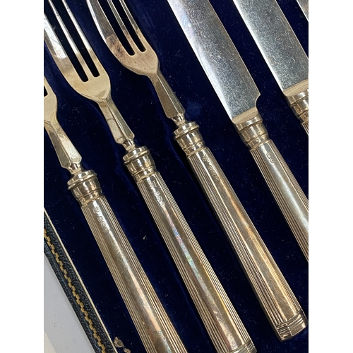 75 - A cased set of silver handled fruit knives and forks, hallmarked for Thomas Bradbury & Sons Ltd, She... 