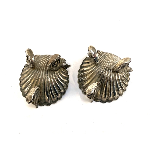 76 - A pair of Victorian silver shell shaped salts on dolphin supports, hallmarked for George Unite, Birm... 