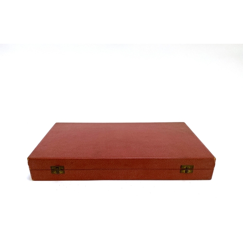 358 - A vintage backgammon set with pieces in a red leather style canvas case, 43cm wide when closed