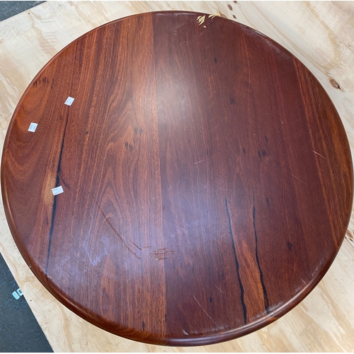 883 - A circular hardwood table on cast iron base, 73cmH