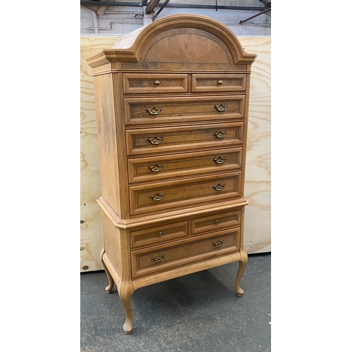 911 - A 20th century chest on chest, the dome top over two short and four long drawers, the base for the f... 