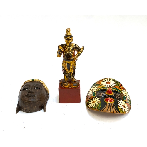 419 - A carved wooden mask of buddha; together with a lacquered Thai carved wooden figure etc (3)